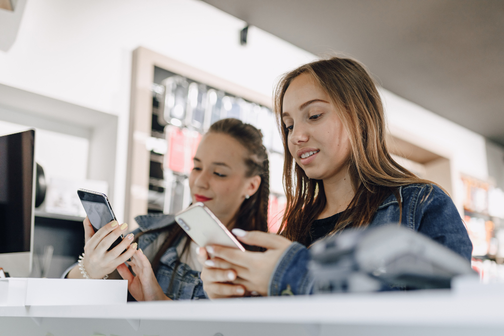 Two girls shopping for phones 